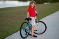 Sporty kid riding bike on a park. Child riding bicycle. Kid learns to ride a bike. Kids on bicycle. Happy child in t Royalty Free Stock Photo