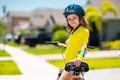 Sporty kid riding bike on a park. Child in safety helmet riding bicycle. Kid learns to ride a bike. Kids on bicycle Royalty Free Stock Photo
