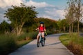 Sporty kid riding bike on a park. Child in safety helmet riding bicycle. Kid learns to ride a bike. Kids on bicycle Royalty Free Stock Photo