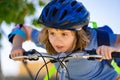 Sporty kid riding bike on a park. Child in safety helmet riding bicycle. Kid learns to ride a bike. Kids on bicycle Royalty Free Stock Photo