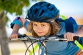 Sporty kid riding bike on a park. Child in safety helmet riding bicycle. Kid learns to ride a bike. Kids on bicycle Royalty Free Stock Photo