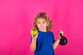 Sporty kids, studio isolated portrait. Child boy raising a kettlebell. Cute child training with kettlebell. Kids fitness Royalty Free Stock Photo