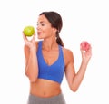 Sporty lady choosing apple over donut