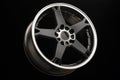 Sporty light black alloy wheel with a white matte rim, close-up Royalty Free Stock Photo