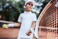 Sporty little girl preparing to serve tennis ball