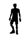 Black silhouette of a man wearing soccer uniform playing ball in the field. Royalty Free Stock Photo