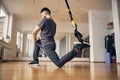 Sporty male doing a TRX lunge exercise Royalty Free Stock Photo