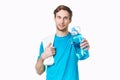 sporty man in blue t-shirt water bottle towels workout Royalty Free Stock Photo