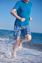 Sporty man during jogging on a evening beach Royalty Free Stock Photo