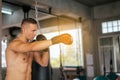 Sporty men boxer punching at a boxing gym,Selective focus hand