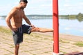 Sporty man doing workout stretching exercises for legs outdoors Royalty Free Stock Photo