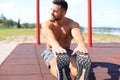 Sporty man doing workout stretching exercises for legs outdoors Royalty Free Stock Photo