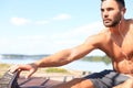 Sporty man doing workout stretching exercises for legs outdoors Royalty Free Stock Photo