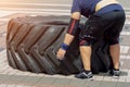 Sporty man flipping a tyre during a cross fit work out training outdoor Royalty Free Stock Photo