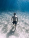 Sporty Man Freediver Stay On Sand Bottom Underwater In Sea
