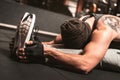 A sporty man in the gym is doing Yoga exercises. Paschimottanasana position: forward bending when seated.