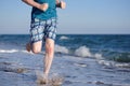 Sporty man during jogging on a evening beach Royalty Free Stock Photo