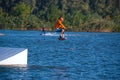 Sporty man is jumping on a wakeboard Royalty Free Stock Photo