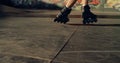 Sporty man performing tricks on roller skates at modern urban skate park.