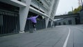 Sporty man practicing skateboarding outside. Skater falling in city stadium.