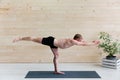 Sporty man practicing yoga, warrior pose Royalty Free Stock Photo