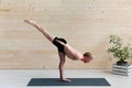 Sporty man practicing yoga, warrior pose Royalty Free Stock Photo