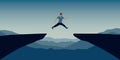 sporty man successful jumping over a cliff on blue mountain landscape