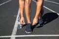 Sporty man tying shoelaces before running at stadium Royalty Free Stock Photo