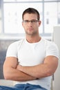 Sporty man wearing glasses sitting arms crossed Royalty Free Stock Photo