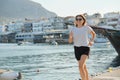 Sporty mature woman jogging running at seaside promenade Royalty Free Stock Photo