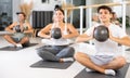 Men and women doing pilates exercises with fitness ball at gym Royalty Free Stock Photo