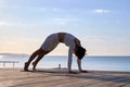 Sporty Middle Aged Woman Practicing Yoga Outdoors, Athletic Female In Activewear Exercising On Wooden Pier Near Sea Royalty Free Stock Photo