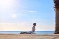 Sporty Middle Aged Woman Practicing Yoga Outdoors, Athletic Female In Activewear Exercising On Wooden Pier Near Sea Royalty Free Stock Photo
