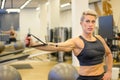 Sporty middle-aged woman working out with stretch bands