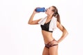 Sporty muscular woman drinking water