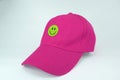 Pink cap with smiley happy face isolated on white background
