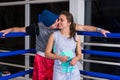 Sporty pair kissing while standing near blue corner of a regular Royalty Free Stock Photo