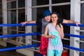 Sporty pair standing near blue corner of a regular boxing ring Royalty Free Stock Photo