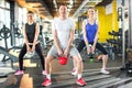 Sporty people working out with kettle bells in gym. Royalty Free Stock Photo