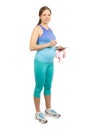 Sporty pregnant woman with a measure tape in the hands, isolated