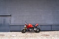 Sporty racing powerful stylish modern red motorcycle stands parked on the road