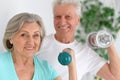 Sporty senior couple with dumbbells