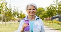 Sporty senior woman with bottle of water at park Royalty Free Stock Photo