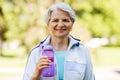 Sporty senior woman with bottle of water at park Royalty Free Stock Photo