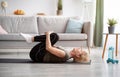 Sporty senior woman doing exercises on yoga mat indoors, blank space Royalty Free Stock Photo