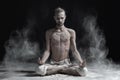 Sporty serene young man meditating sitting in cross-legged yoga lotus pose, Padmasana with palms in mudra