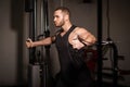 Sporty sexy men with great abdominal muscles in black sportswear working out in the gym. Royalty Free Stock Photo