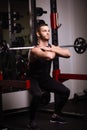 Sporty sexy men with great abdominal muscles in black sportswear working out in the gym. Royalty Free Stock Photo