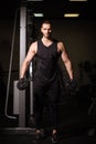 Sporty sexy men with great abdominal muscles in black sportswear working out in the gym. Royalty Free Stock Photo