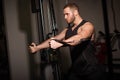 Sporty sexy men with great abdominal muscles in black sportswear working out in the gym. Royalty Free Stock Photo